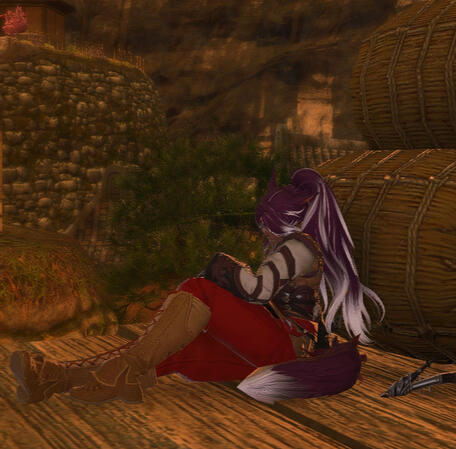 Lili'a is slouched over, napping, next to rice barrels in Namai. He is wearing a simple white togi with leather wrappings, red pants, and brown boots.